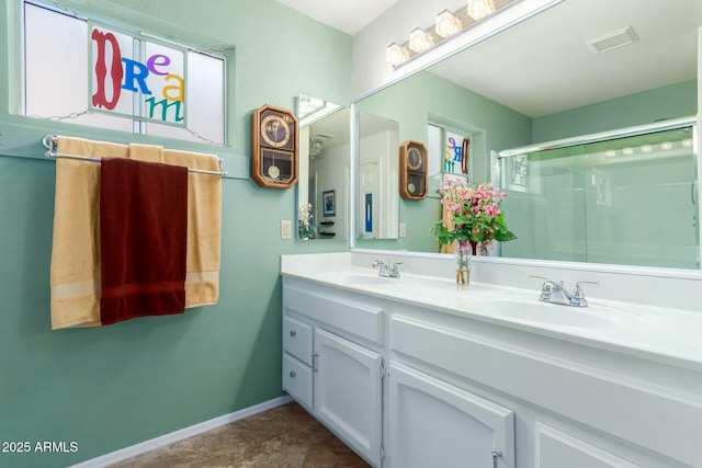 bathroom with vanity, walk in shower, and a wealth of natural light