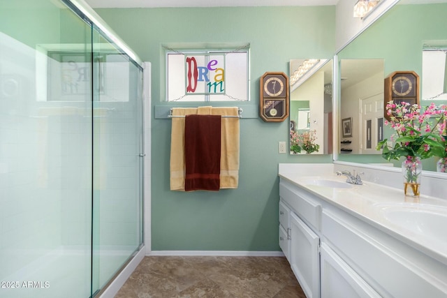 bathroom with a shower with door and vanity