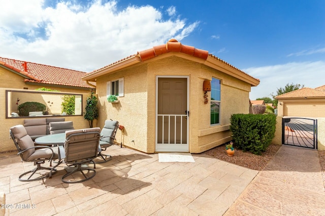 exterior space with a patio area and an outbuilding