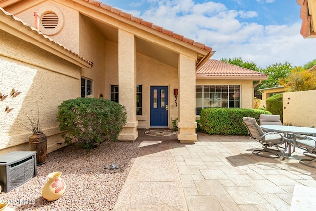 entrance to property featuring a patio