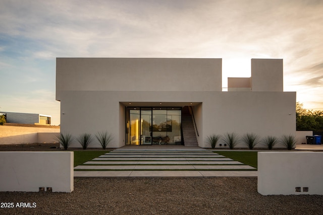 rear view of house with stucco siding
