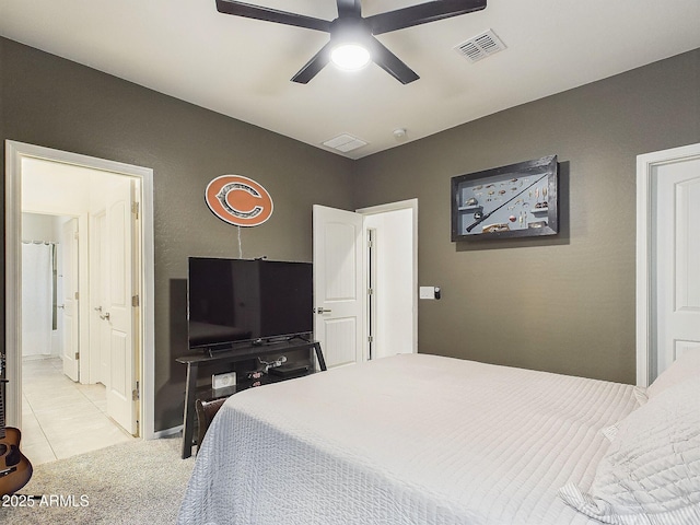 tiled bedroom featuring connected bathroom and ceiling fan