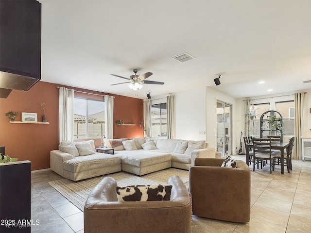 living room featuring light tile patterned floors and ceiling fan