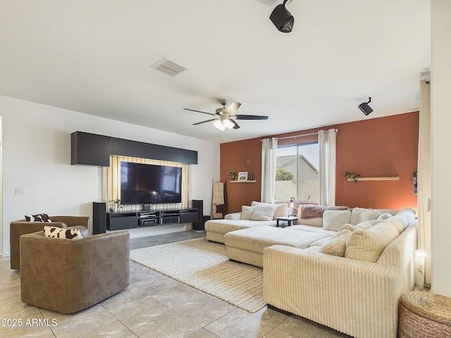 living room featuring light tile patterned floors and ceiling fan