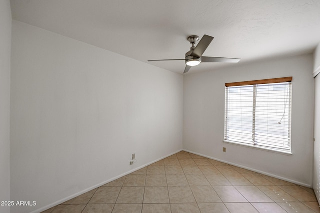 unfurnished room featuring light tile patterned floors, baseboards, and ceiling fan