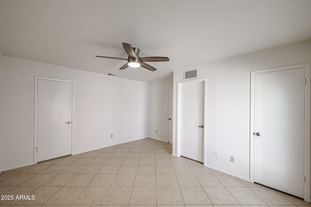 unfurnished bedroom with ceiling fan, visible vents, and light tile patterned flooring