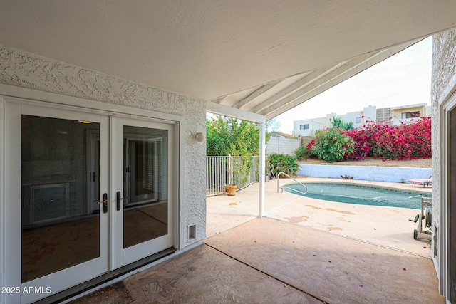 view of pool featuring a patio area, a fenced in pool, french doors, and fence