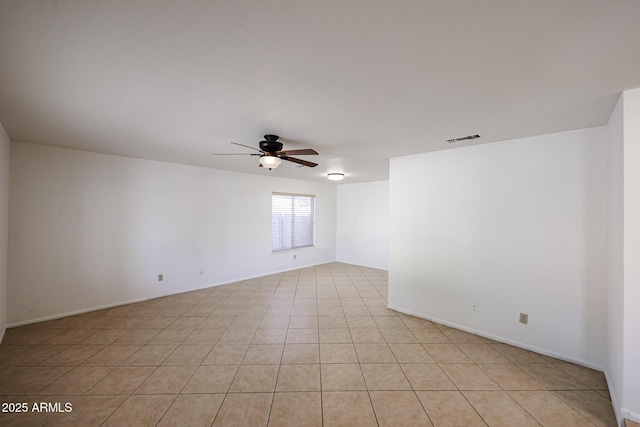 empty room with light tile patterned floors, visible vents, and ceiling fan