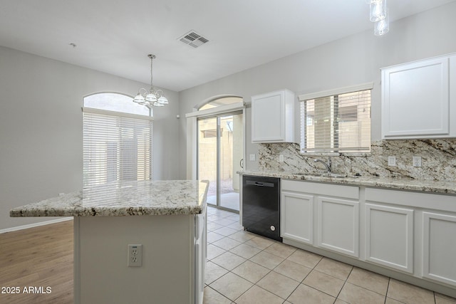 kitchen with white cabinets, tasteful backsplash, sink, pendant lighting, and dishwasher