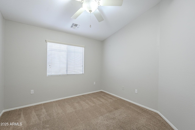 carpeted spare room featuring ceiling fan