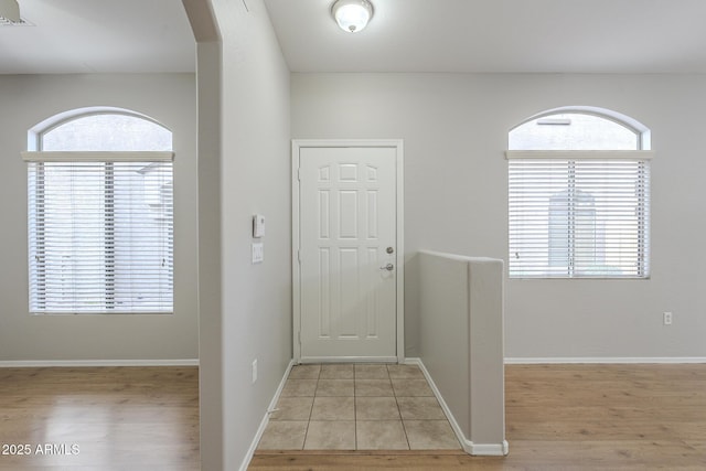 foyer entrance featuring plenty of natural light and light tile patterned flooring