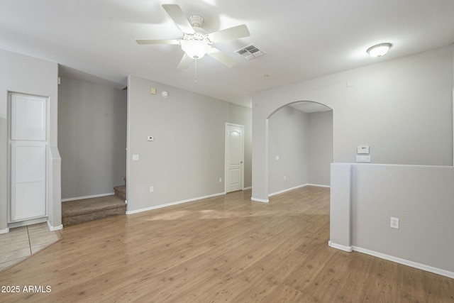 unfurnished room with ceiling fan and light wood-type flooring