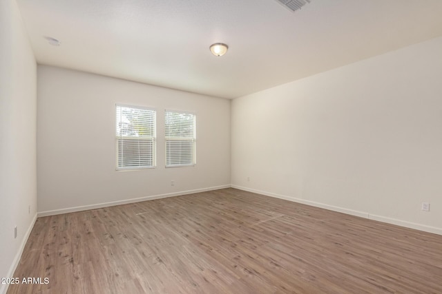 unfurnished room with light wood-type flooring