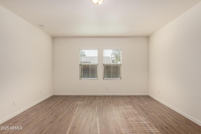 unfurnished room featuring hardwood / wood-style flooring