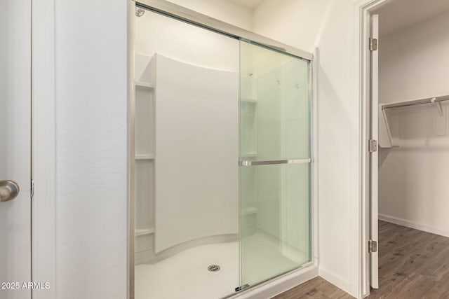 bathroom featuring hardwood / wood-style floors and a shower with door