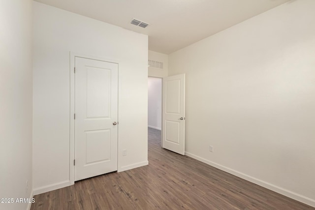 unfurnished bedroom featuring dark wood-type flooring