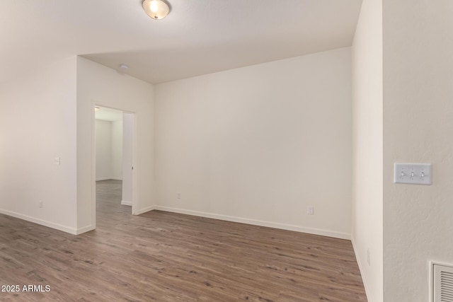 unfurnished room featuring dark wood-type flooring