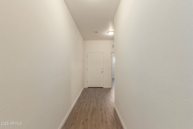 hall with dark wood-type flooring