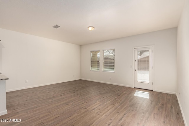 spare room with dark wood-type flooring