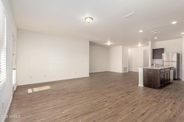 unfurnished living room with dark hardwood / wood-style floors and sink