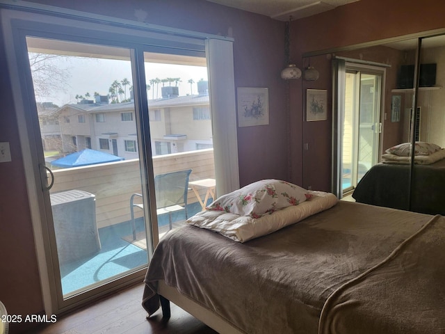 bedroom featuring hardwood / wood-style floors and a closet