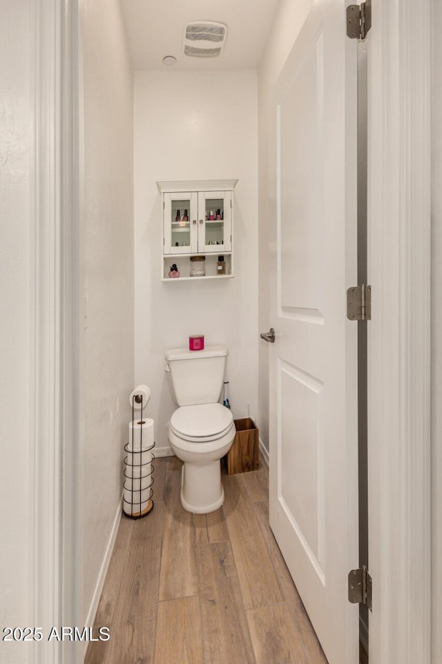 2631 S Sulley Dr Unit 106, Gilbert, AZ 85295 - bathroom featuring wood finished floors, toilet, and baseboards