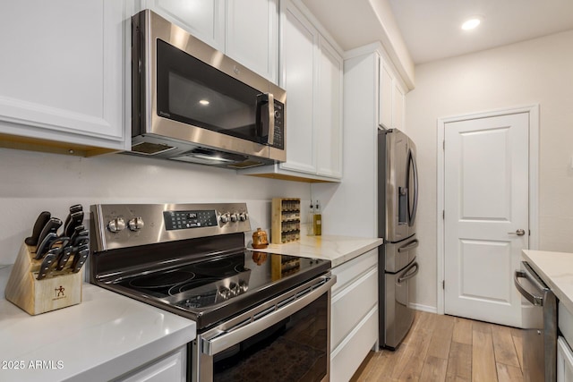 2631 S Sulley Dr Unit 106, Gilbert, AZ 85295 - kitchen with appliances with stainless steel finishes, light wood-style floors, white cabinetry, light stone counters, and recessed lighting