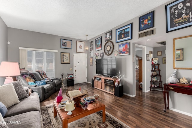 living room with a textured ceiling and dark wood-type flooring