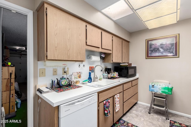 kitchen featuring dishwasher, sink, and light brown cabinetry