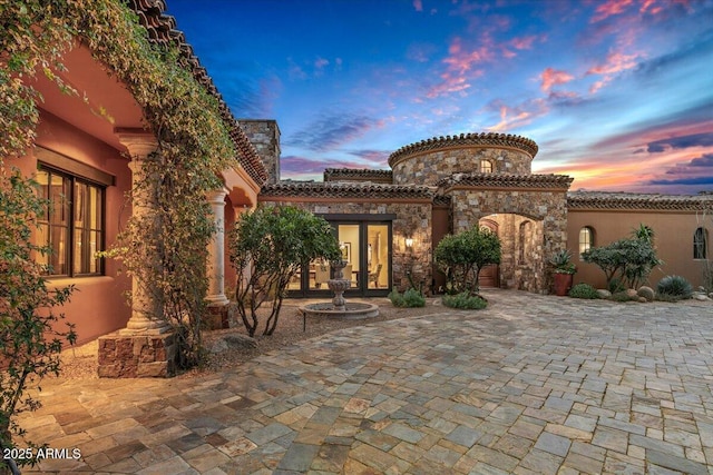 view of patio terrace at dusk