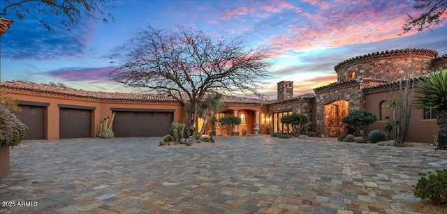 mediterranean / spanish-style house with a garage