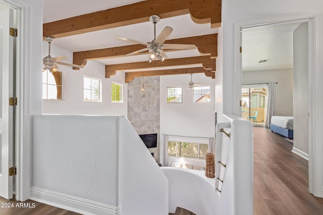 interior space with beamed ceiling and wood-type flooring