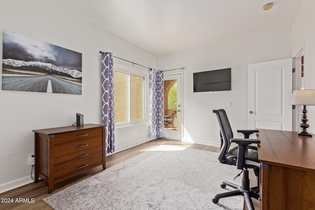 home office with wood-type flooring