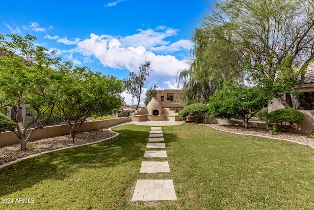 view of yard with an outdoor fireplace