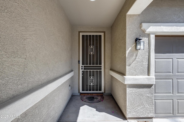 property entrance featuring stucco siding