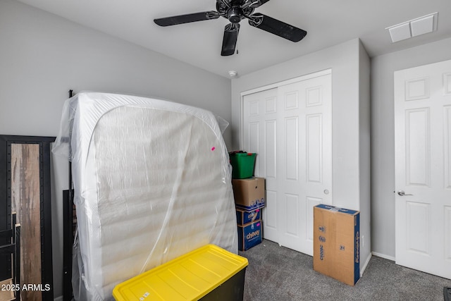 carpeted bedroom featuring visible vents, a ceiling fan, and a closet