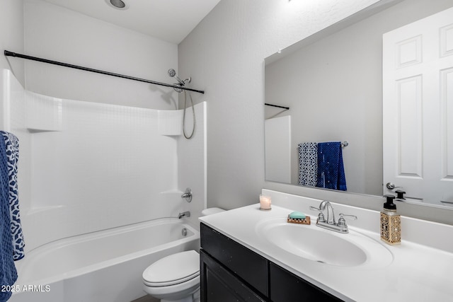 bathroom with toilet, shower / tub combination, and vanity