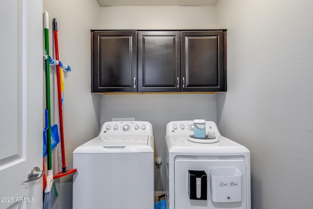 laundry area featuring washer and clothes dryer and cabinet space