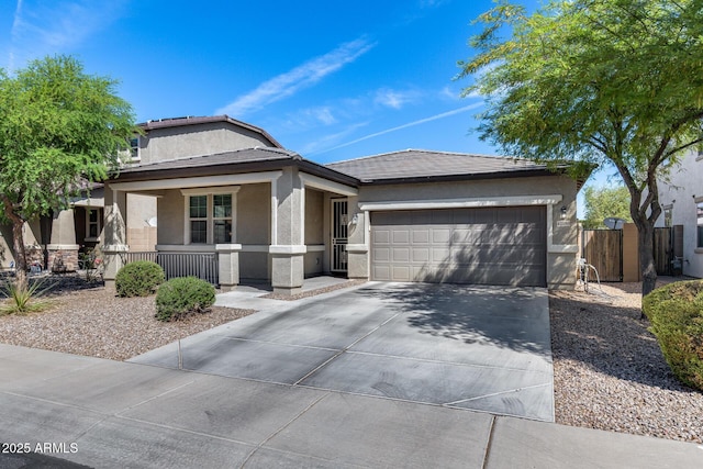 view of front of house featuring stucco siding, covered porch, a garage, a tile roof, and concrete driveway