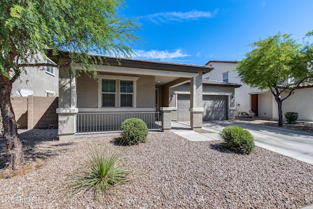 view of front of property with driveway, fence, stucco siding, a porch, and a garage