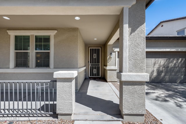 doorway to property featuring stucco siding and fence