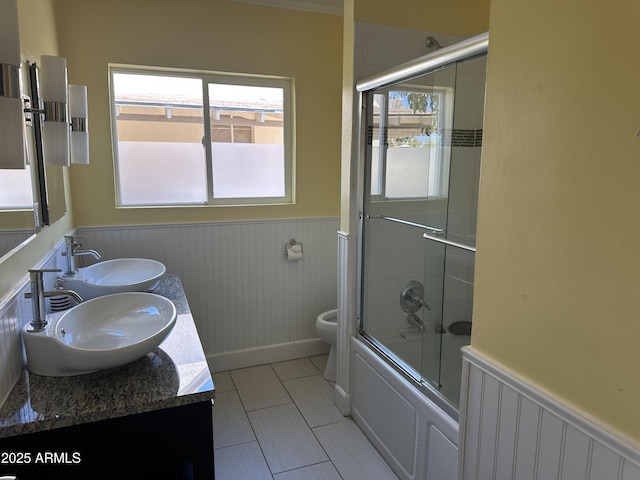 full bathroom featuring tile patterned floors, toilet, combined bath / shower with glass door, vanity, and radiator