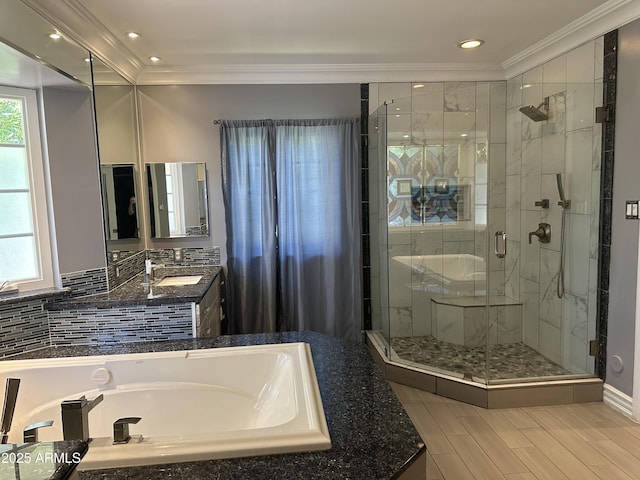 bathroom featuring vanity, plenty of natural light, crown molding, and a shower with shower door