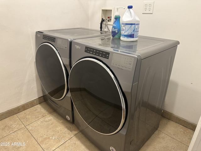 laundry area featuring washing machine and clothes dryer