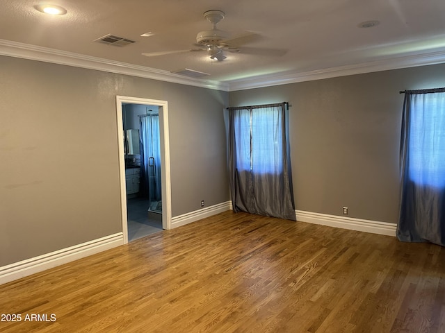 spare room featuring ornamental molding, hardwood / wood-style floors, and ceiling fan