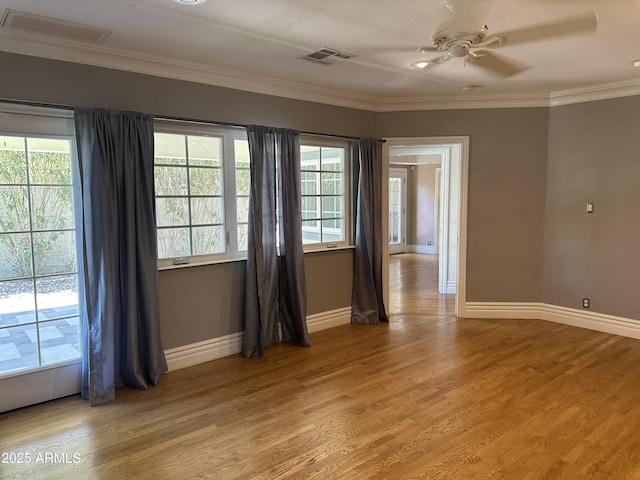 spare room with crown molding, ceiling fan, and hardwood / wood-style floors