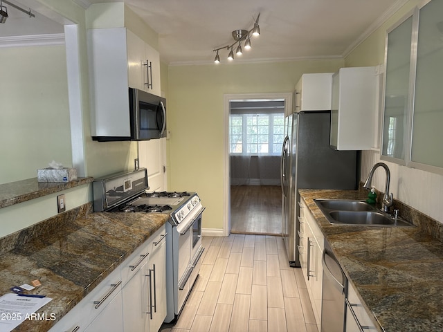 kitchen with white cabinetry, sink, ornamental molding, and stainless steel appliances