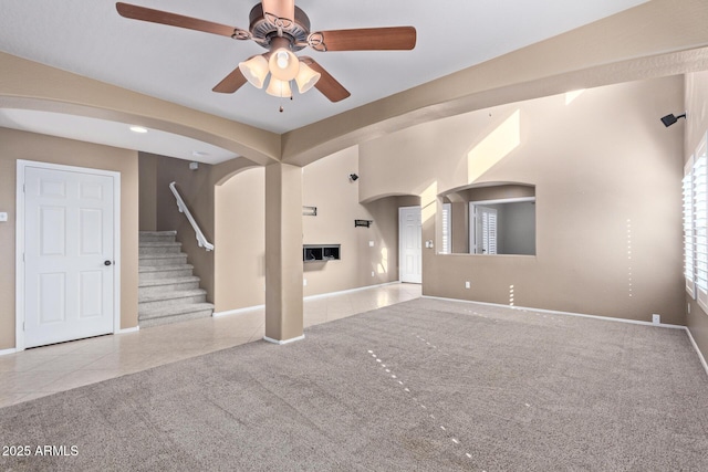 unfurnished living room featuring ceiling fan and light tile patterned floors