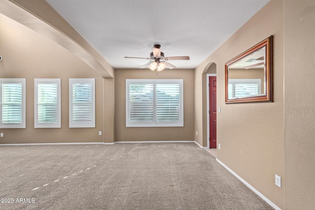 empty room with ceiling fan and light colored carpet