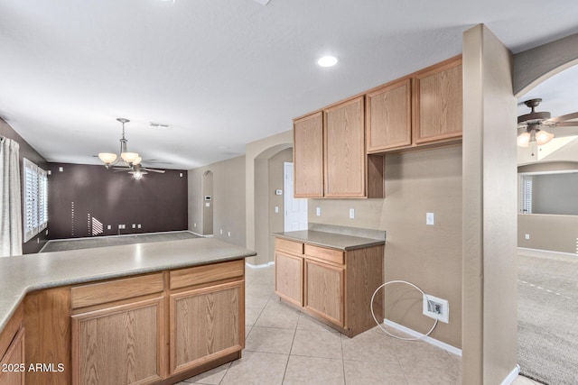 kitchen featuring light tile patterned floors and ceiling fan with notable chandelier